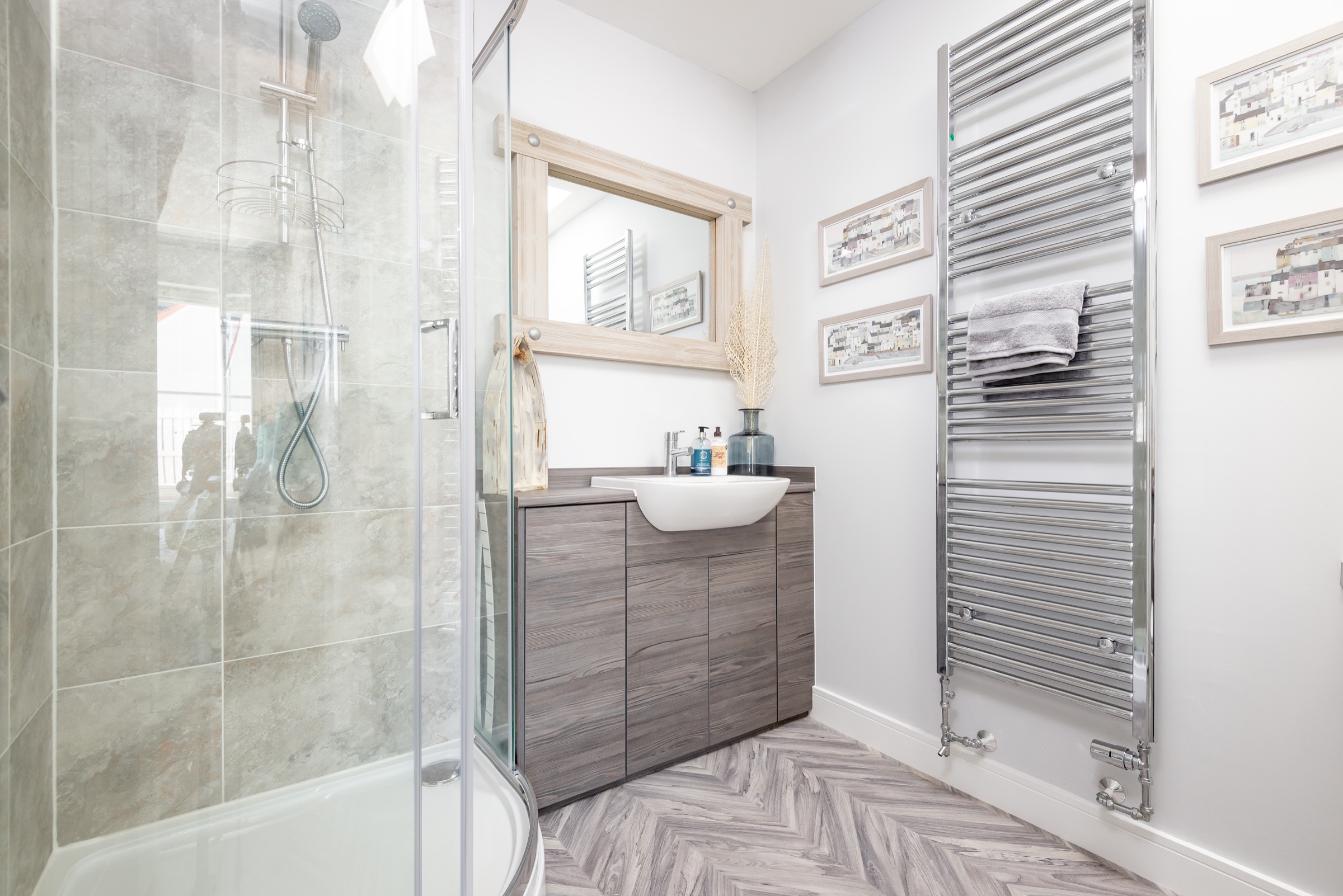 Bathroom at Dormie House with a corner shower and chevron tiled floor