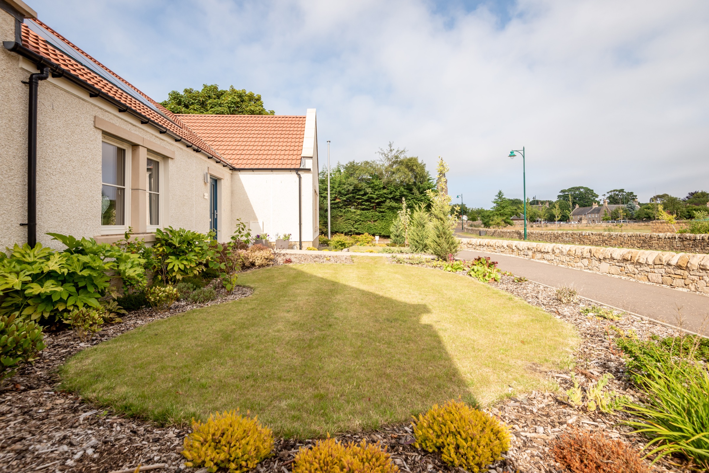Garden at Dormie House with lawn and views towards the village